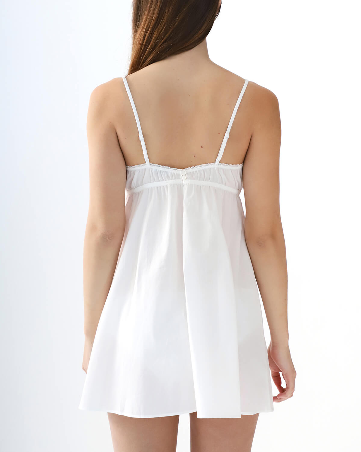 White slip dress on a model against a white background