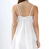 White slip dress on a model against a white background