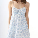 Woman wearing a blue floral dress on a white background