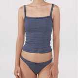 A model wearing a navy blue and white striped tank top and thong against a plain light gray background.