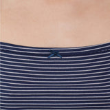 Close-up of a navy blue and white horizontally striped ribbed top with a small navy bow at the neckline, worn by a model.