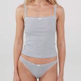 A woman modeling a tank top and matching thong with a fine horizontal stripe pattern in navy blue and white. The tank has a square-neck with thin shoulder straps and a small white bow at the center front.