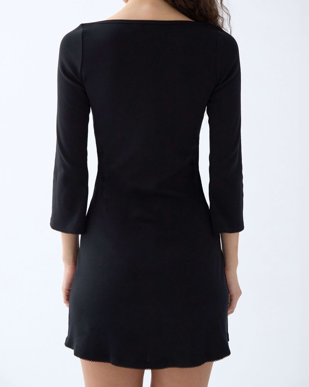 Black dress with 3/4 sleeves on a white background
