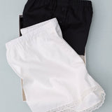 Black and white shorts with lace trim on a light gray background
