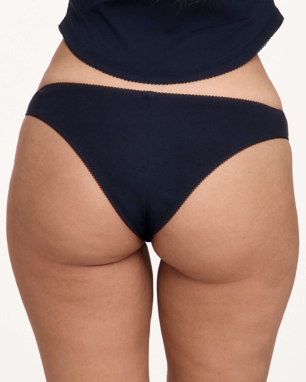 Rear view of a model wearing dark navy blue underwear