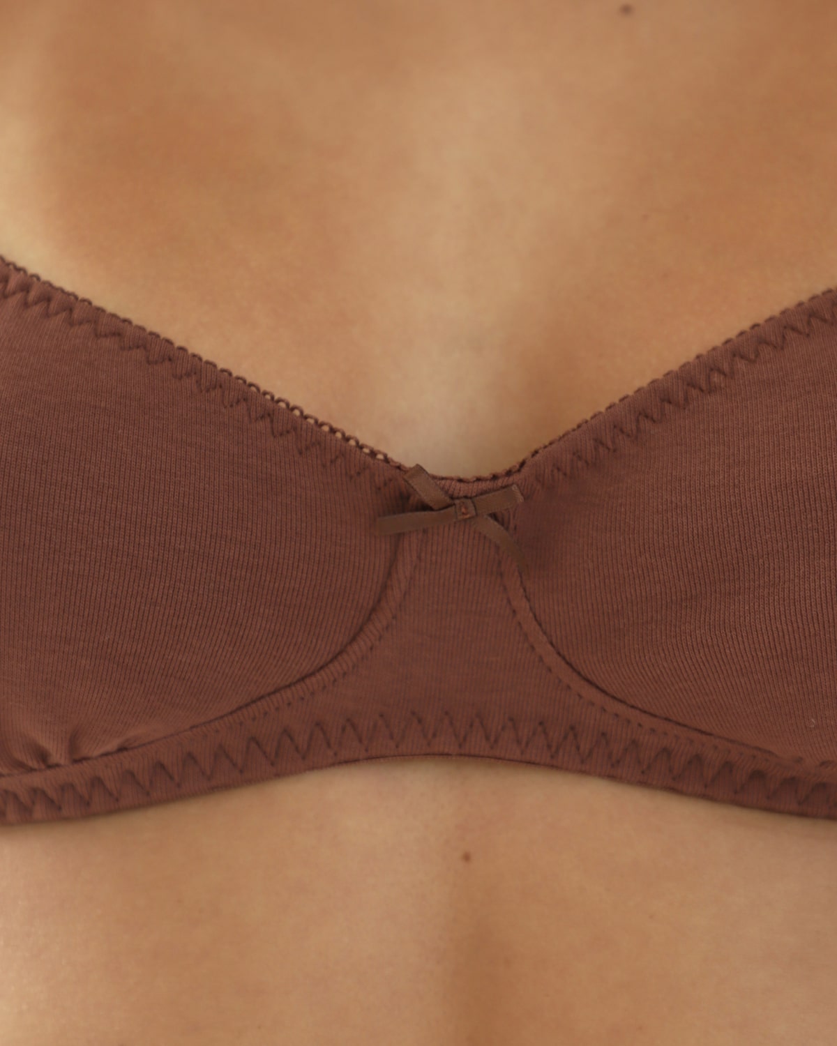 Brown bra on a persons chest