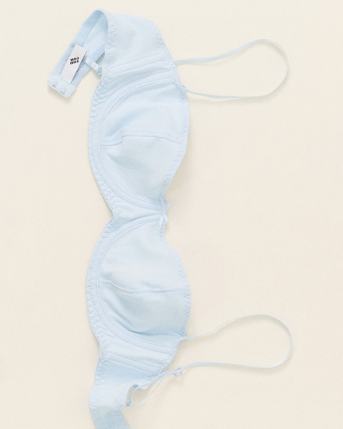 Light blue bra on a beige background