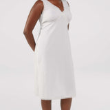White dress with lace details on a plain background
