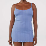 Woman wearing a blue dress against a white background