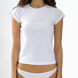 Woman wearing a white t-shirt and underwear set on a plain background