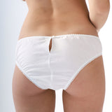 White underwear worn by a person on a light gray background
