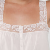 White lace-trimmed top on a neutral background