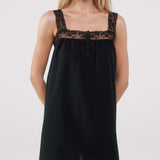 Black dress with lace details on a white background