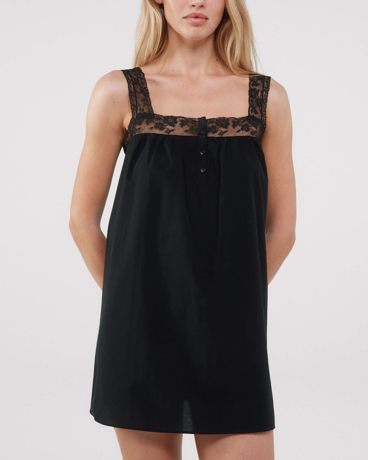 Black dress with lace details on a white background