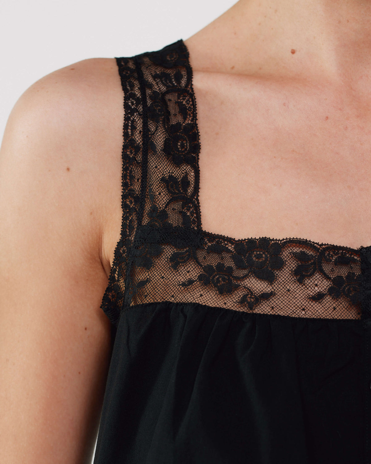 Black lace dress close up on a plain background