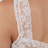 Close-up of a white lace garment on a plain background