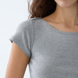 Gray t-shirt worn by a person on a light gray background