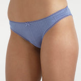 Blue underwear worn by a person on a white background