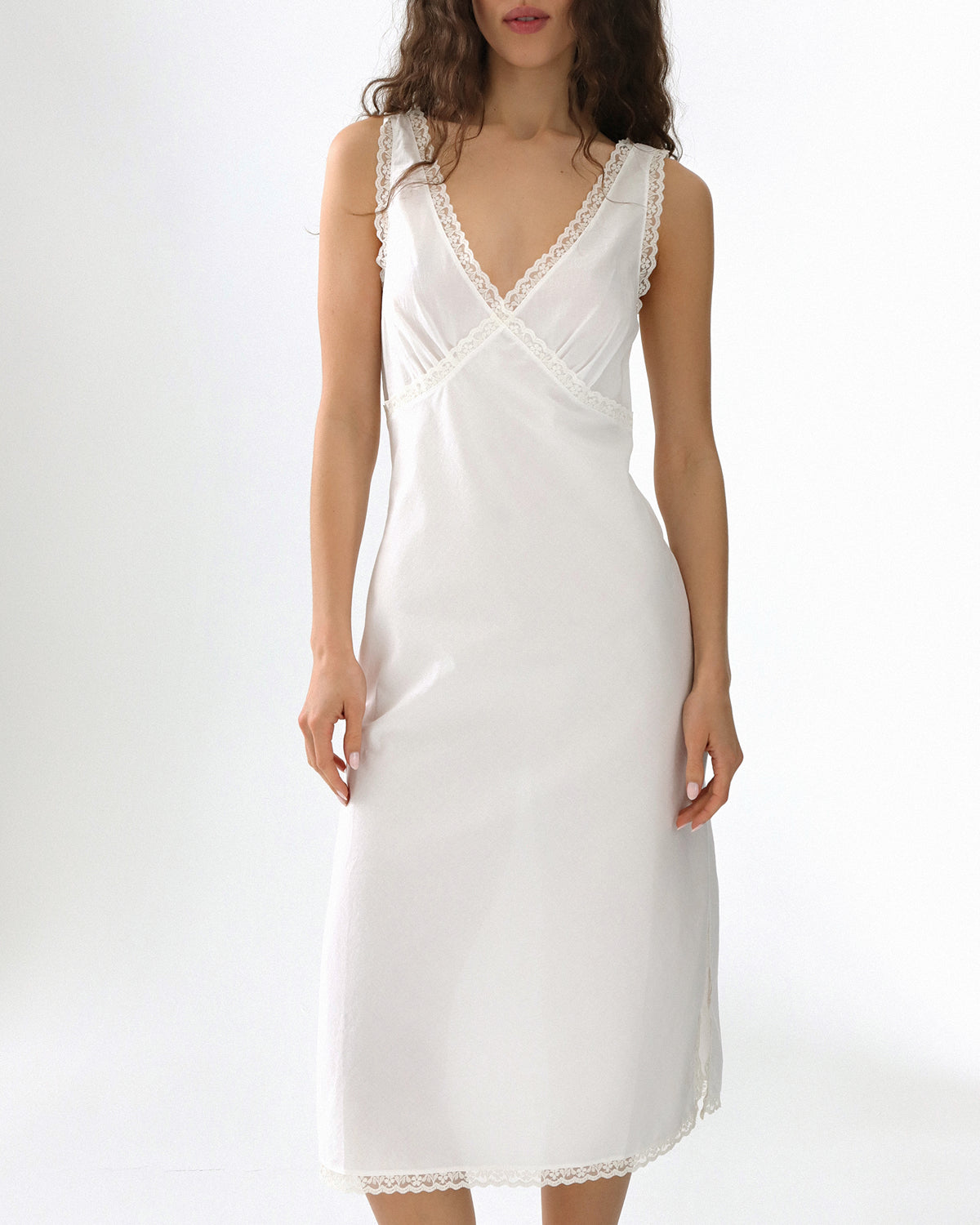 White dress with lace details on a white background