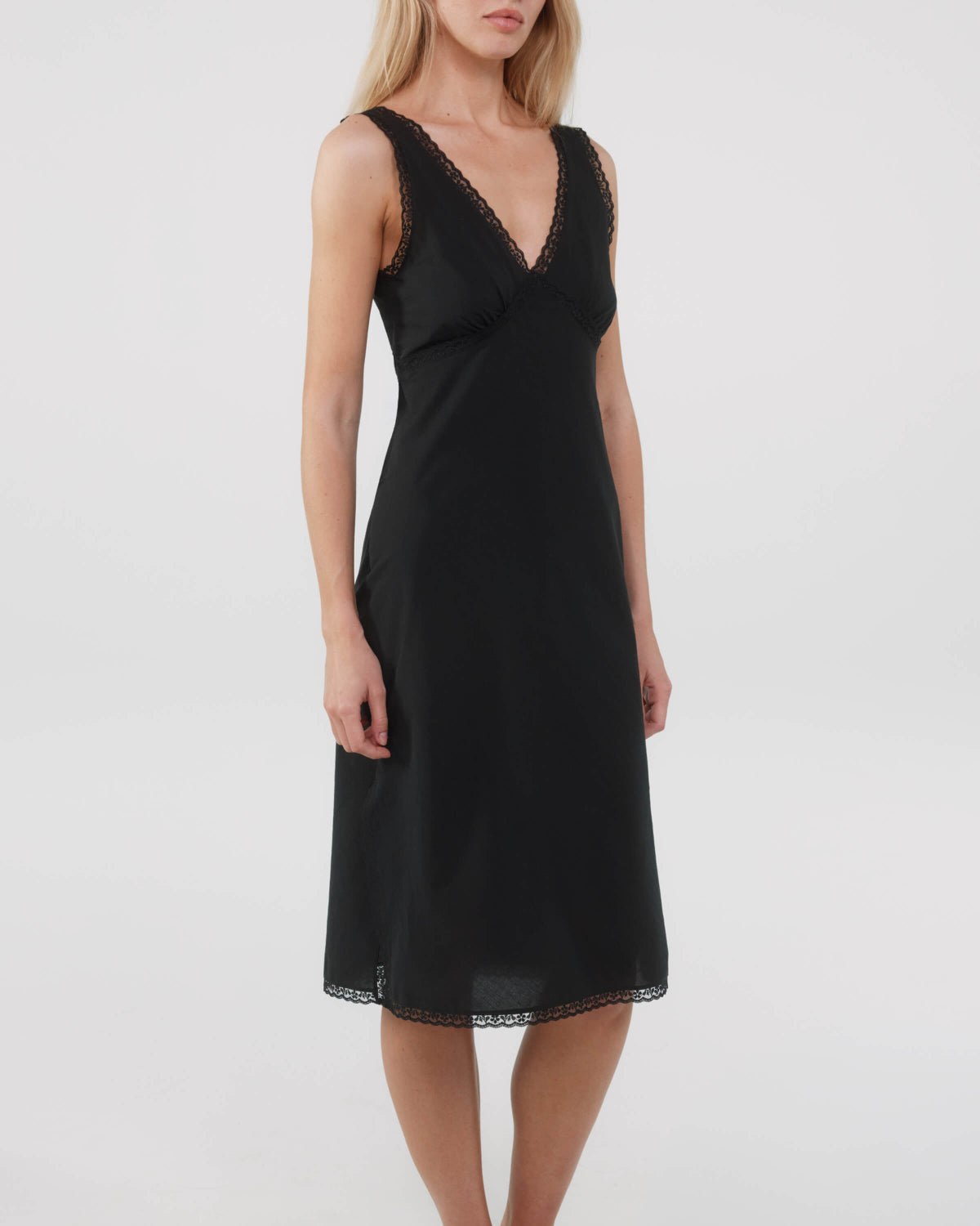 Black dress worn by a model on a white background