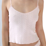 Light pink camisole worn by a person on a light gray background