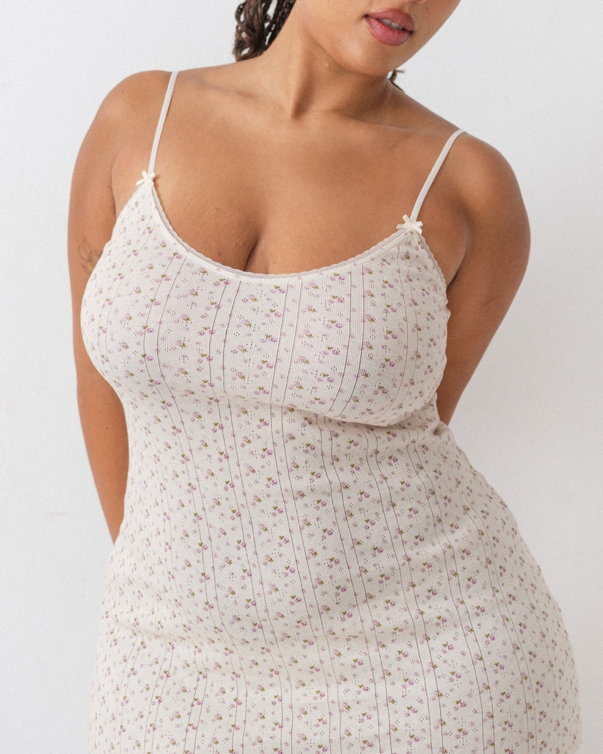 Woman wearing a floral dress against a white background