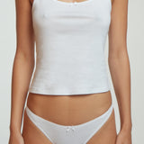Person wearing a white tank top and underwear set on a plain background
