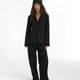 Woman wearing a black outfit on a white background