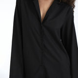Black shirt worn by a person on a white background