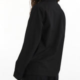 Person wearing a black outfit on a white background
