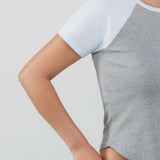Gray and blue crop top worn by a person on a light gray background