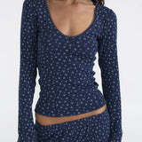 Navy blue long-sleeve top with white pattern on a plain background