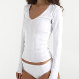 White long-sleeve top and underwear set on a white background
