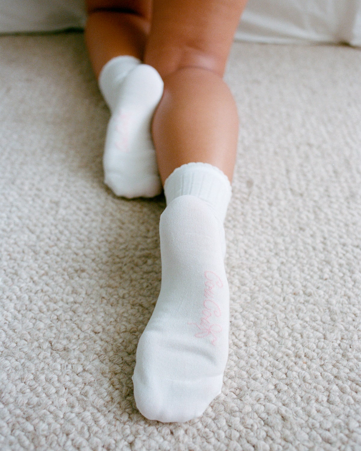 White socks worn on a carpeted floor