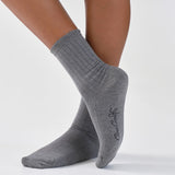 Gray socks with a brand logo on a white background