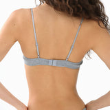 Woman wearing a gray bra and underwear set on a white background