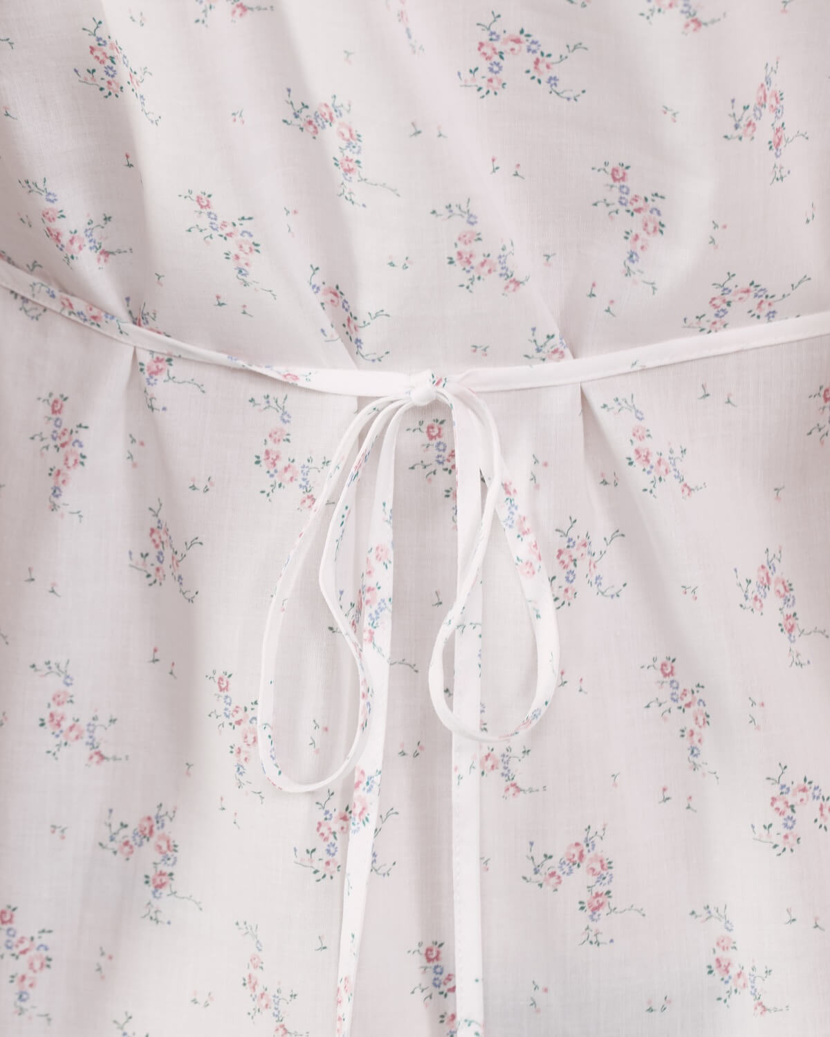 Floral-patterned fabric with a white drawstring on a light background