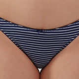Close-up of a person wearing a thong with narrow horizontal navy and white stripes.
