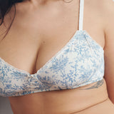White bra with blue floral pattern worn by a person