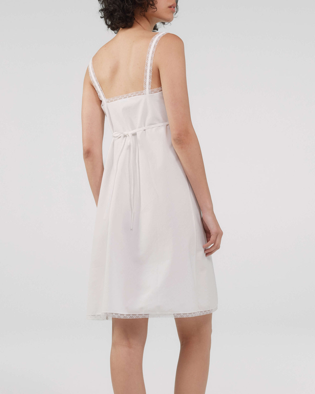 White dress with thin straps on a white background