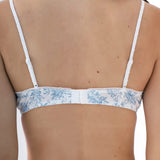 White bra with floral lace details on a white background