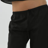 Black pants worn by a person on a light gray background