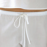 White pants with a drawstring on a light gray background