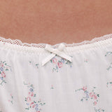 Close up floral-patterned briefs with lace trim and a bow.