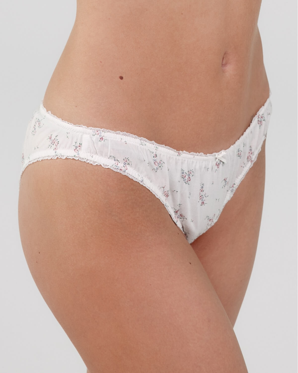 White floral lace underwear on a plain background