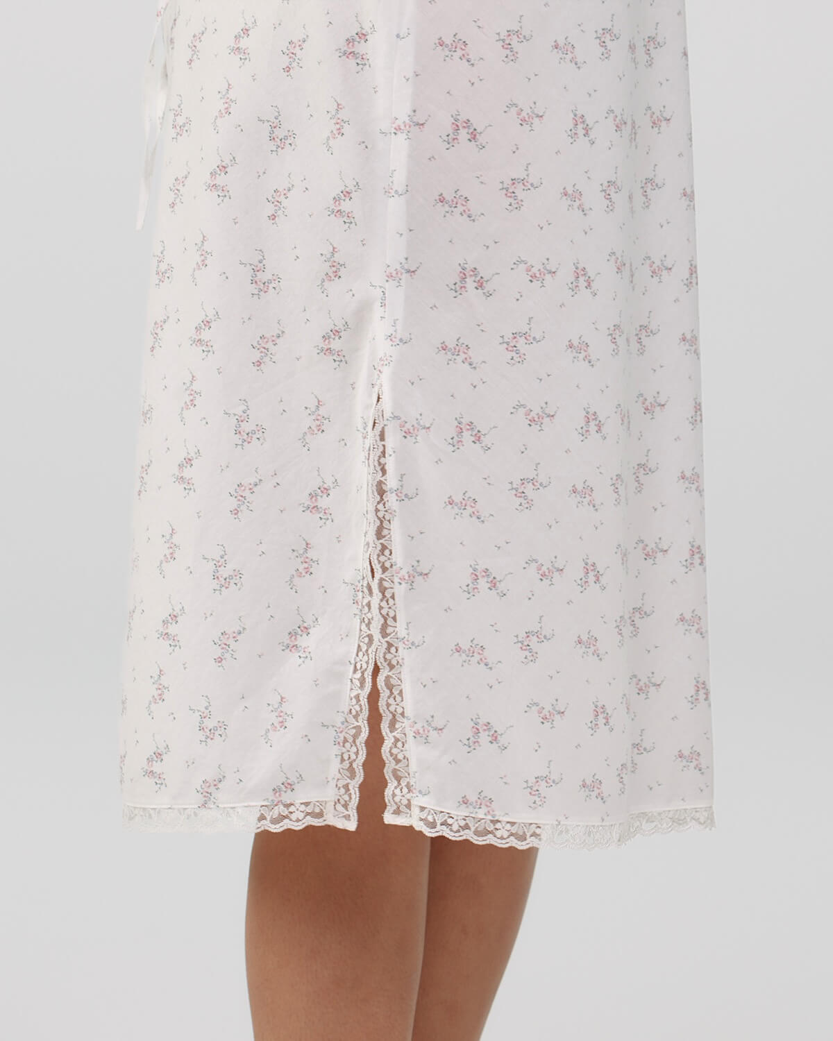White lace nightgown with floral pattern on a light gray background